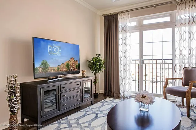 a living room with furniture and large windows