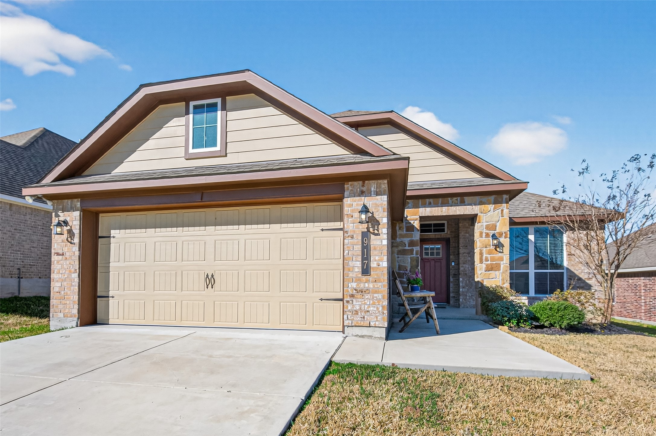 917 Farm Path Brenham, TX 77833 - Photo 2 of 43 a front view of a house with a yard and garage