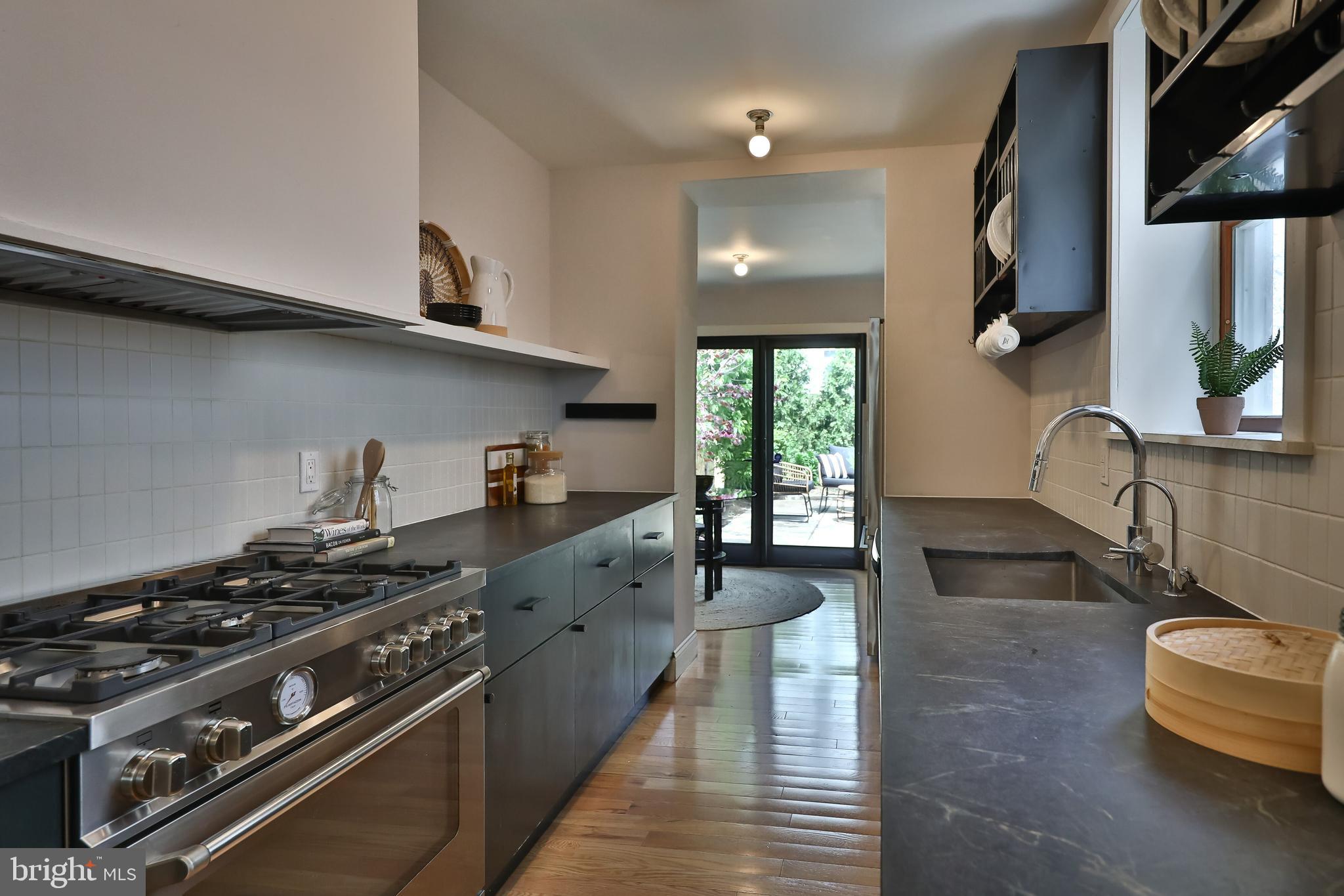 2805 Poplar Street Philadelphia, PA 19130 - Photo 11 of 34 a kitchen with stainless steel appliances granite countertop a stove and a sink