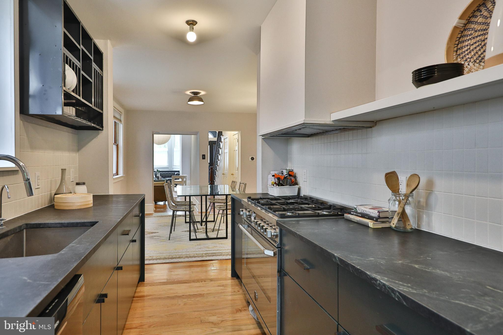 2805 Poplar Street Philadelphia, PA 19130 - Photo 13 of 34 a kitchen with stainless steel appliances granite countertop a sink stove and cabinets