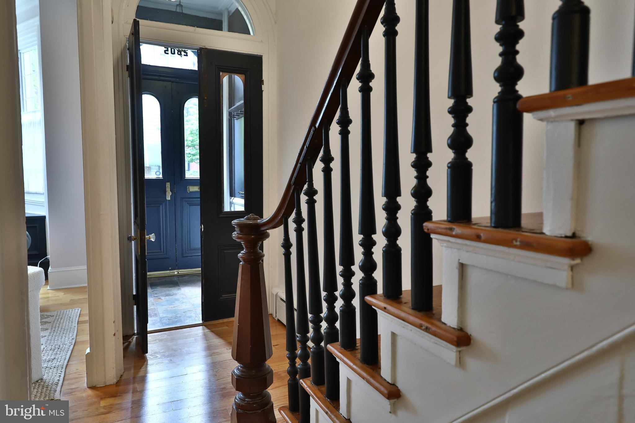 2805 Poplar Street Philadelphia, PA 19130 - Photo 18 of 34 a view of staircase with lots of frames on wall and windows