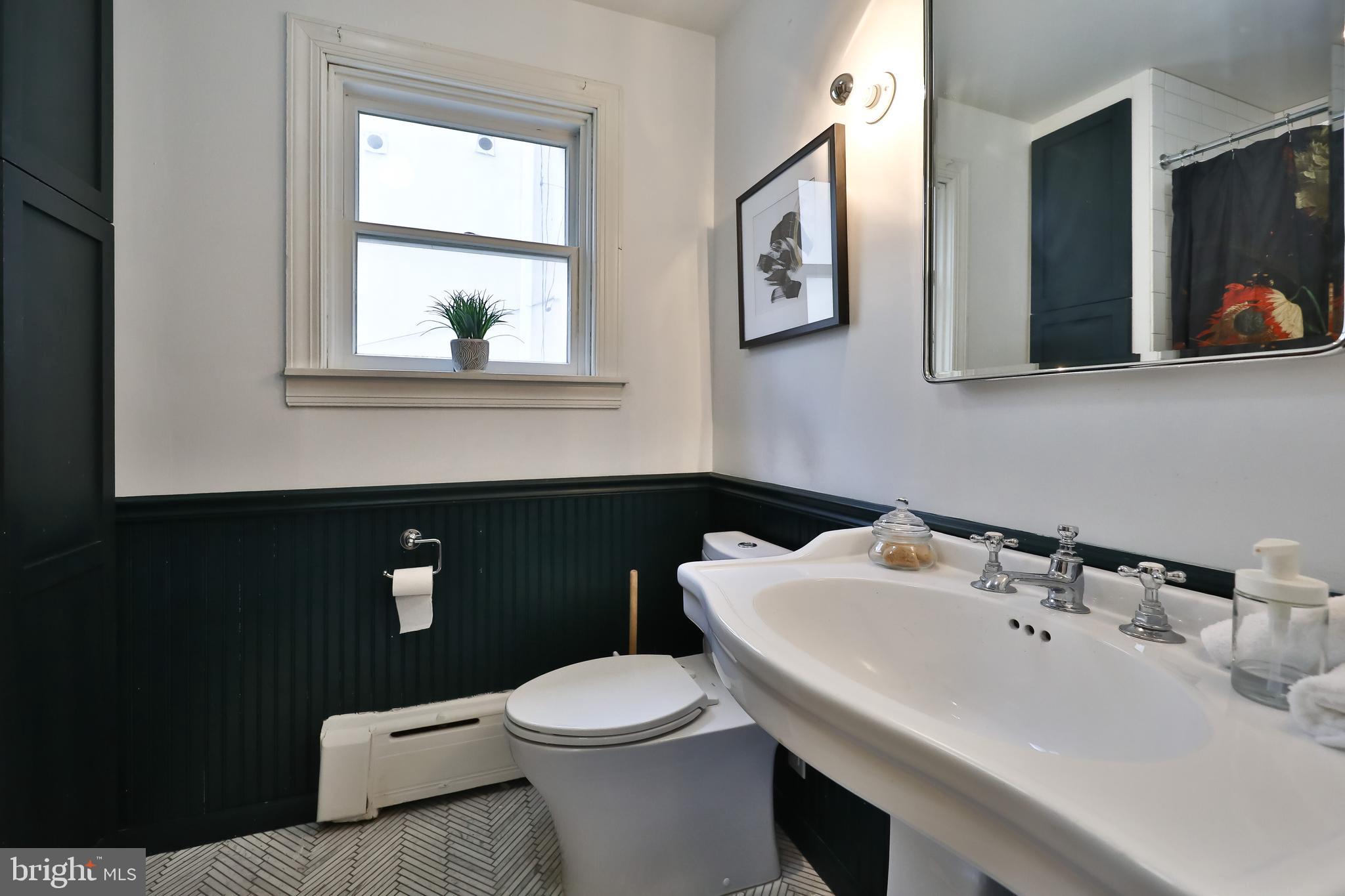 2805 Poplar Street Philadelphia, PA 19130 - Photo 23 of 34 a bathroom with a sink a toilet and mirror