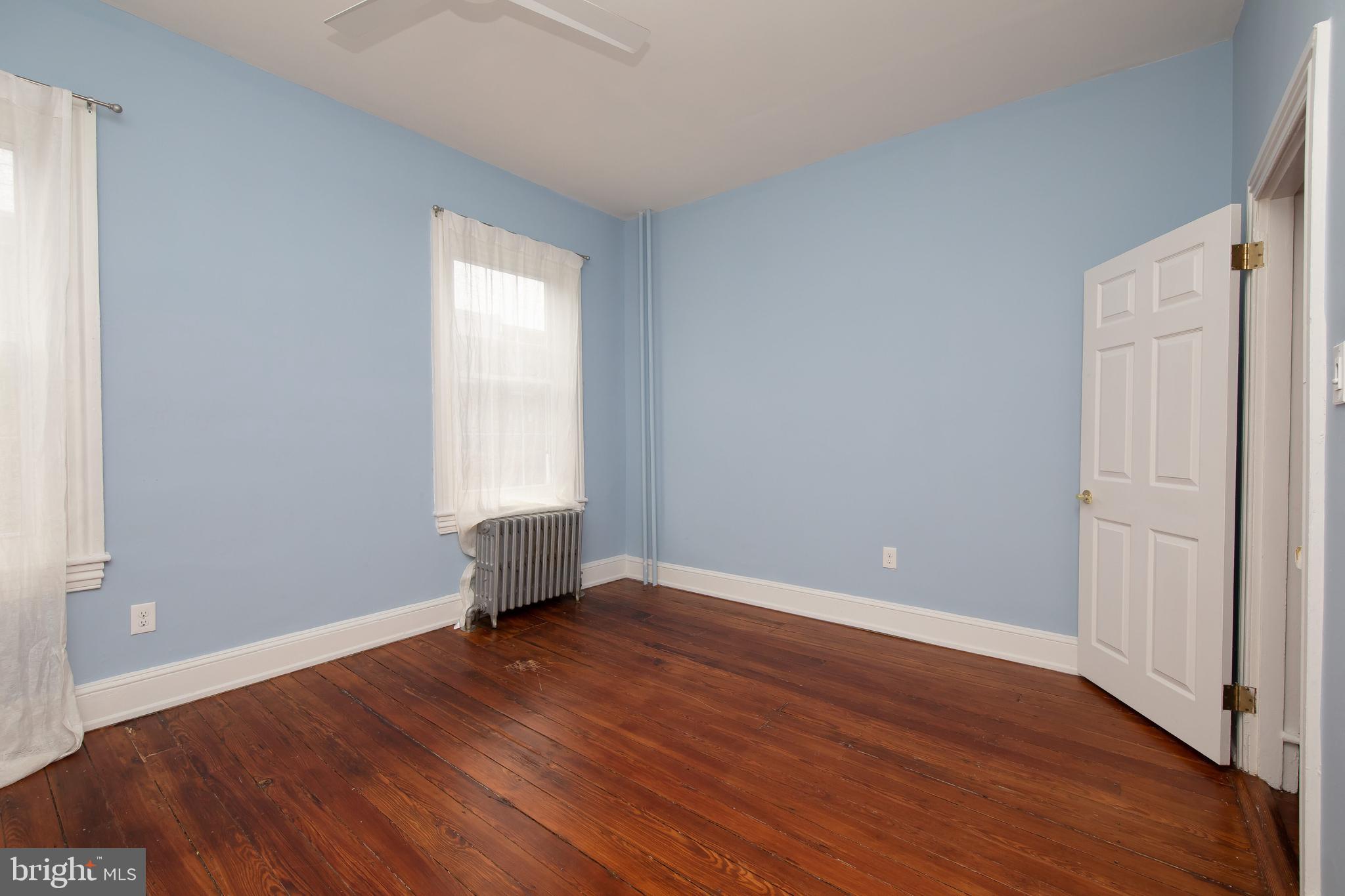 2805 Poplar Street Philadelphia, PA 19130 - Photo 26 of 34 an empty room with wooden floor and windows