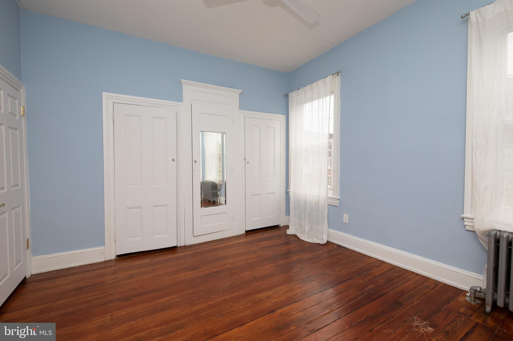 2805 Poplar Street Philadelphia, PA 19130 - Photo 27 of 34 an empty room with wooden floor and sliding door
