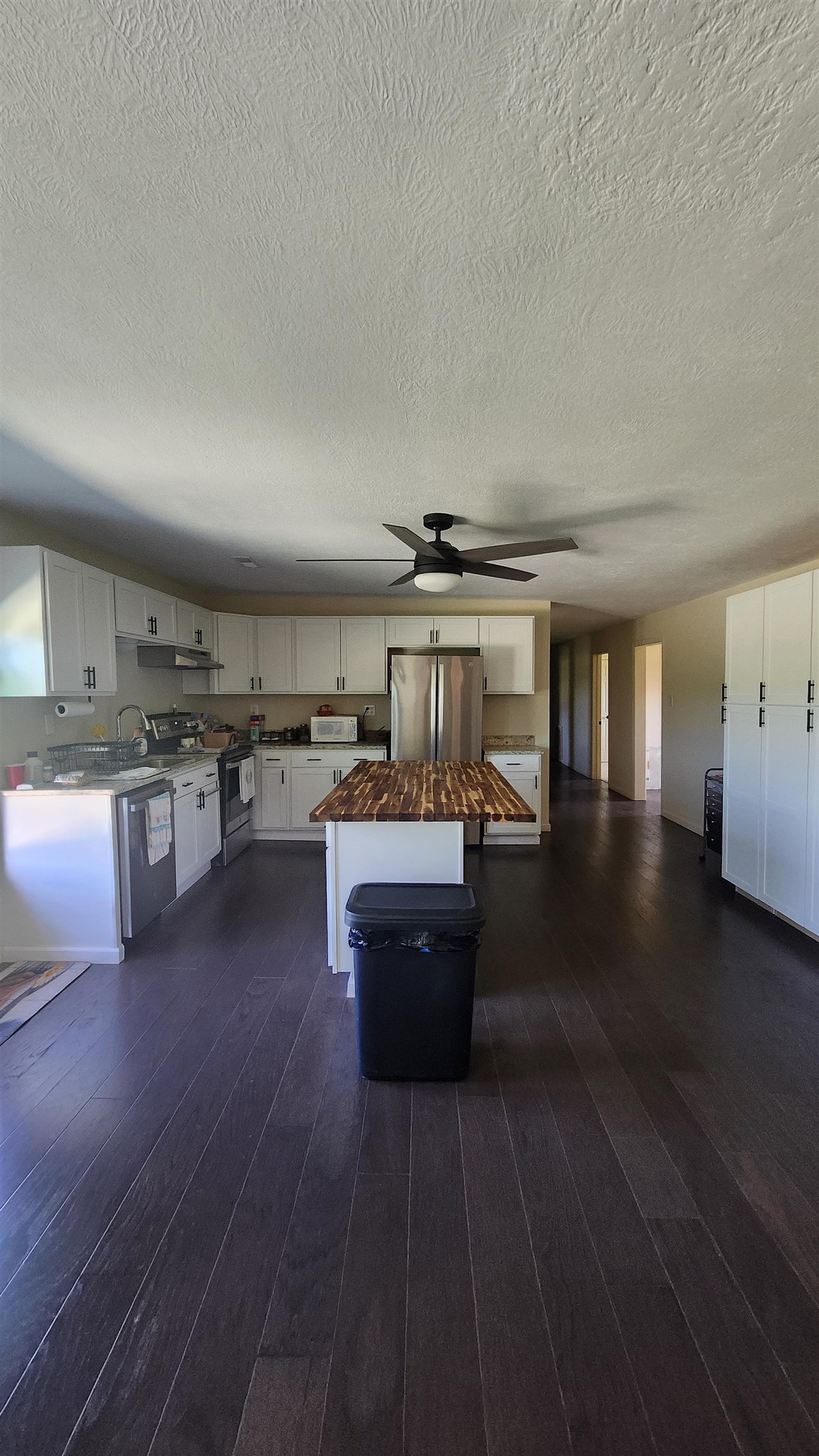 3226 19th Highway West Ripley, TN 38063 - Photo 5 of 18 Kitchen featuring wooden counters, white cabinetry, dark wood-type flooring, stainless steel appliances, and a ceiling fan