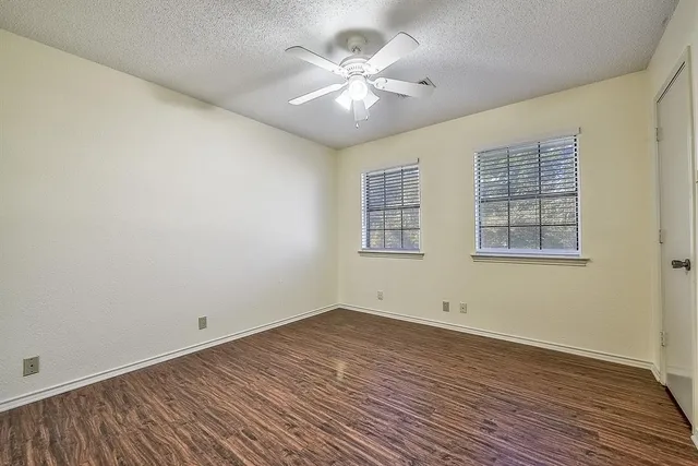 a view of backyard with tree and wooden fence