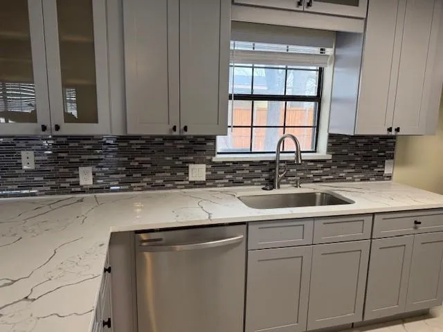 a kitchen with a sink and cabinets