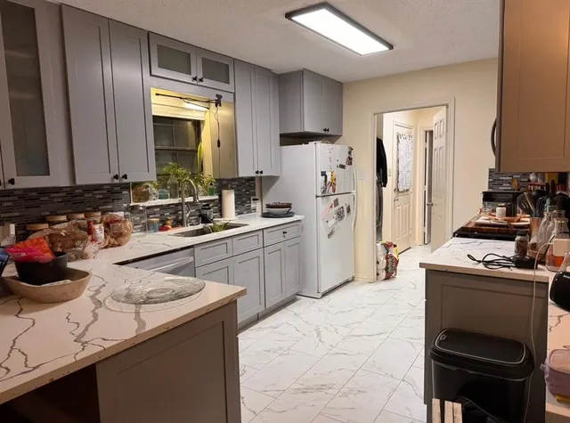 an empty room with wooden floor fireplace and windows