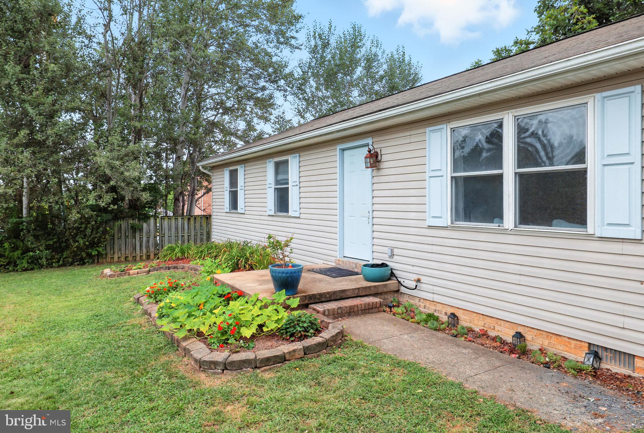 859 Colley Block Road Strasburg, VA 22657 - Photo 41 of 52 a front view of a house with a yard and potted plants