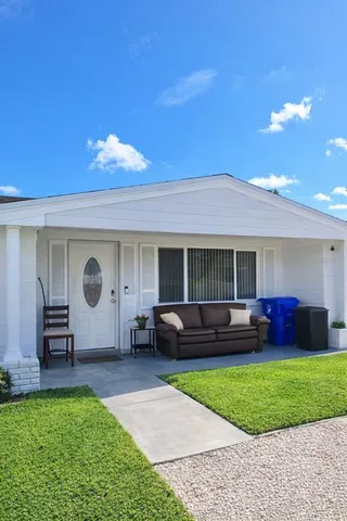 a front view of a house with a garden