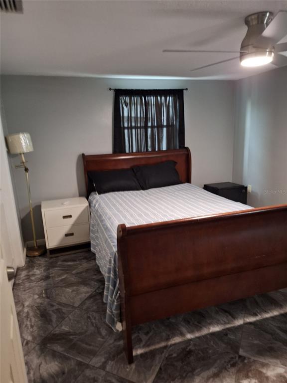 1550 Roundtree Road Holiday, FL 34690 - Photo 4 of 6 a bedroom with a bed and a window