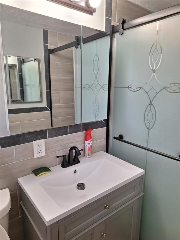 1550 Roundtree Road Holiday, FL 34690 - Photo 5 of 6 a bathroom with a sink and a mirror