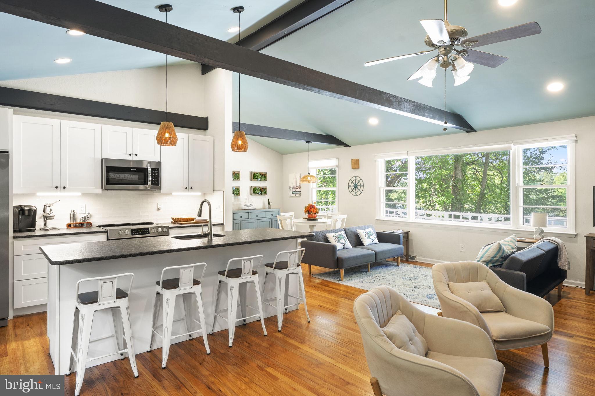 139 Knollwood Road Elkton, MD 21921 - Photo 5 of 57 a large kitchen with stainless steel appliances granite countertop a stove a sink dishwasher a dining table and chairs with wooden floor