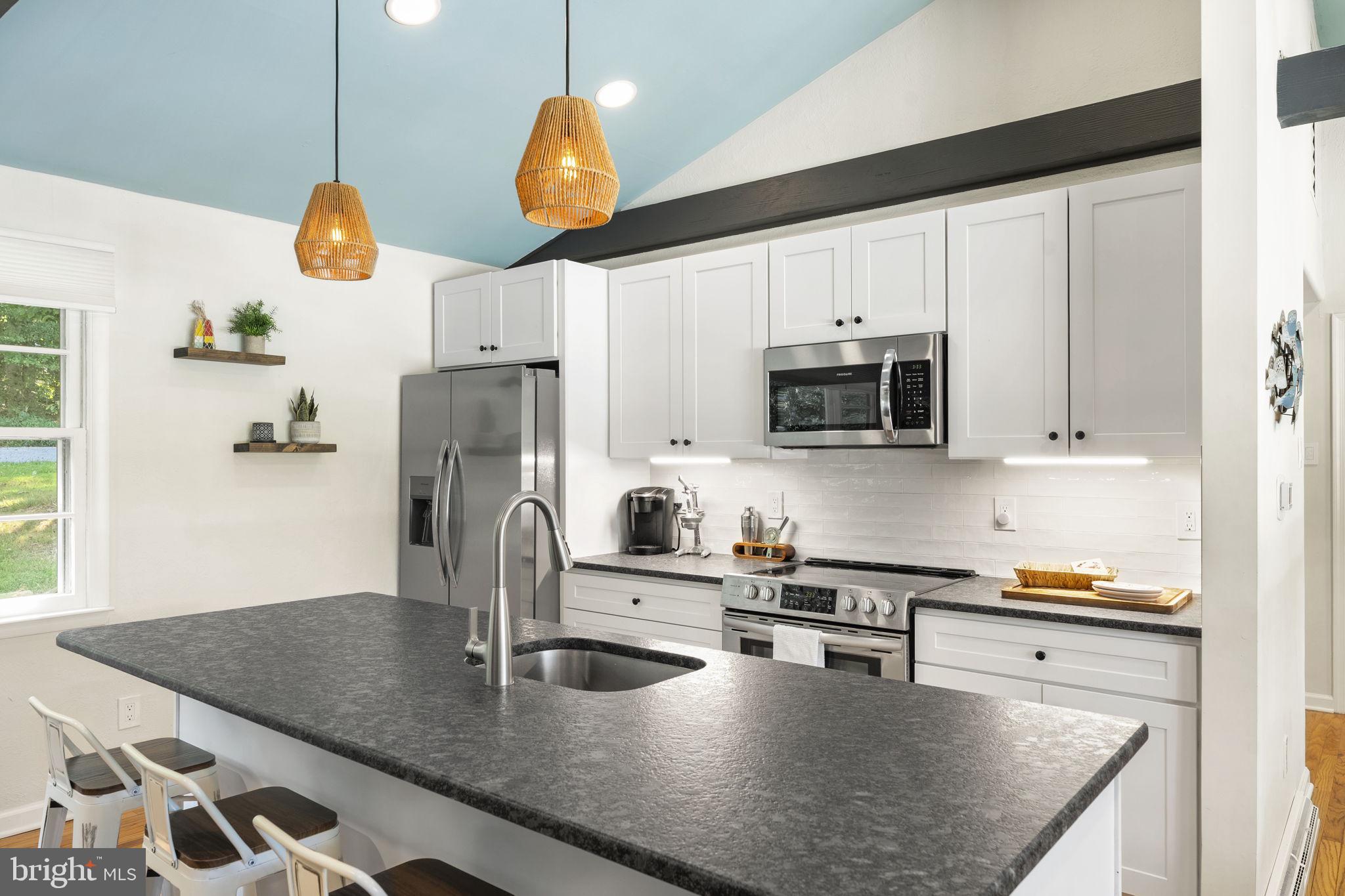 139 Knollwood Road Elkton, MD 21921 - Photo 8 of 57 a kitchen with stainless steel appliances granite countertop a sink a stove and a microwave