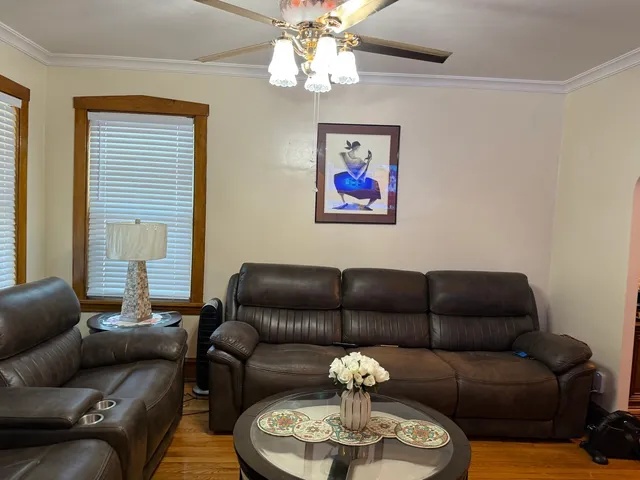a living room with furniture a rug and a window