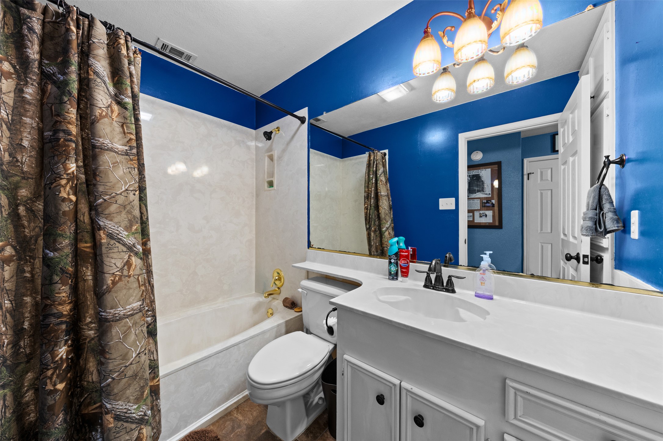 1512 Panther Loop Pflugerville, TX 78660 - Photo 8 of 40 A well-appointed bathroom offers a vanity with ample counter space and a classic tub/shower combination.