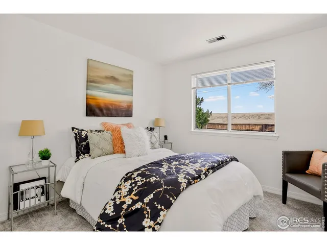 a bedroom with a bed and a painting on the wall