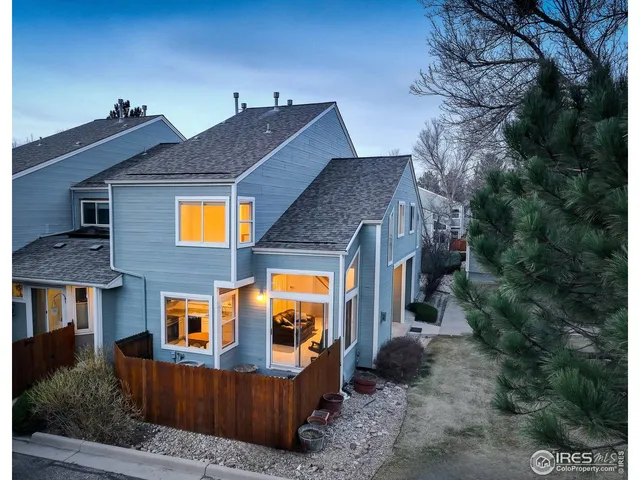 a view of house with a yard and balcony