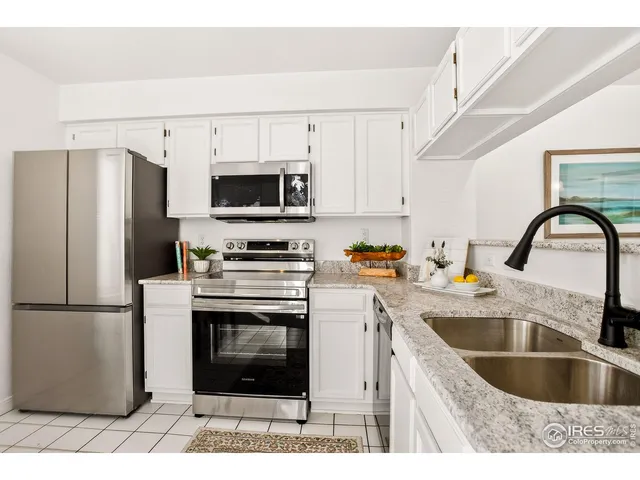 a kitchen with stainless steel appliances kitchen island a white cabinets and a counter top space