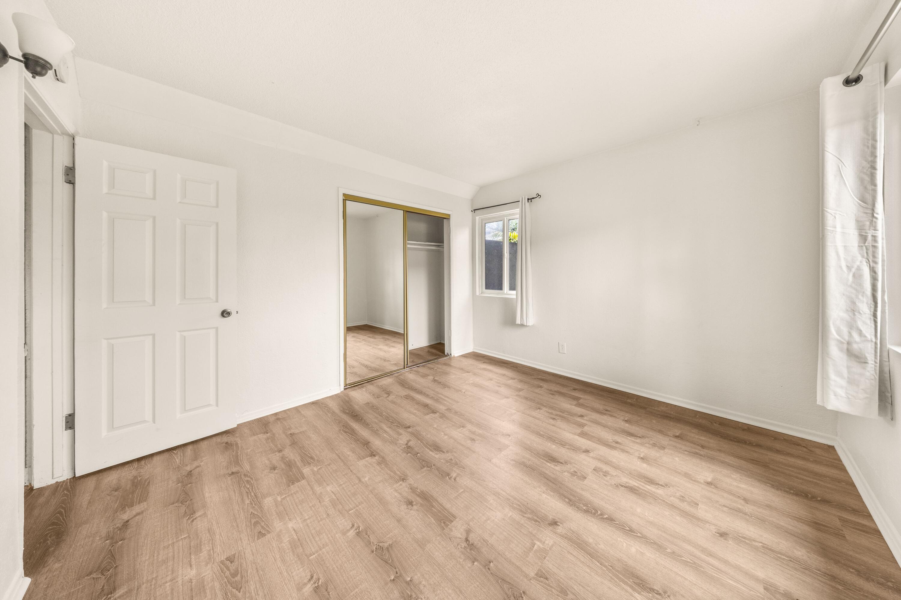 6597 Trigo Road Goleta, CA 93117 - Photo 11 of 20 a view of empty room with wooden floor and fan