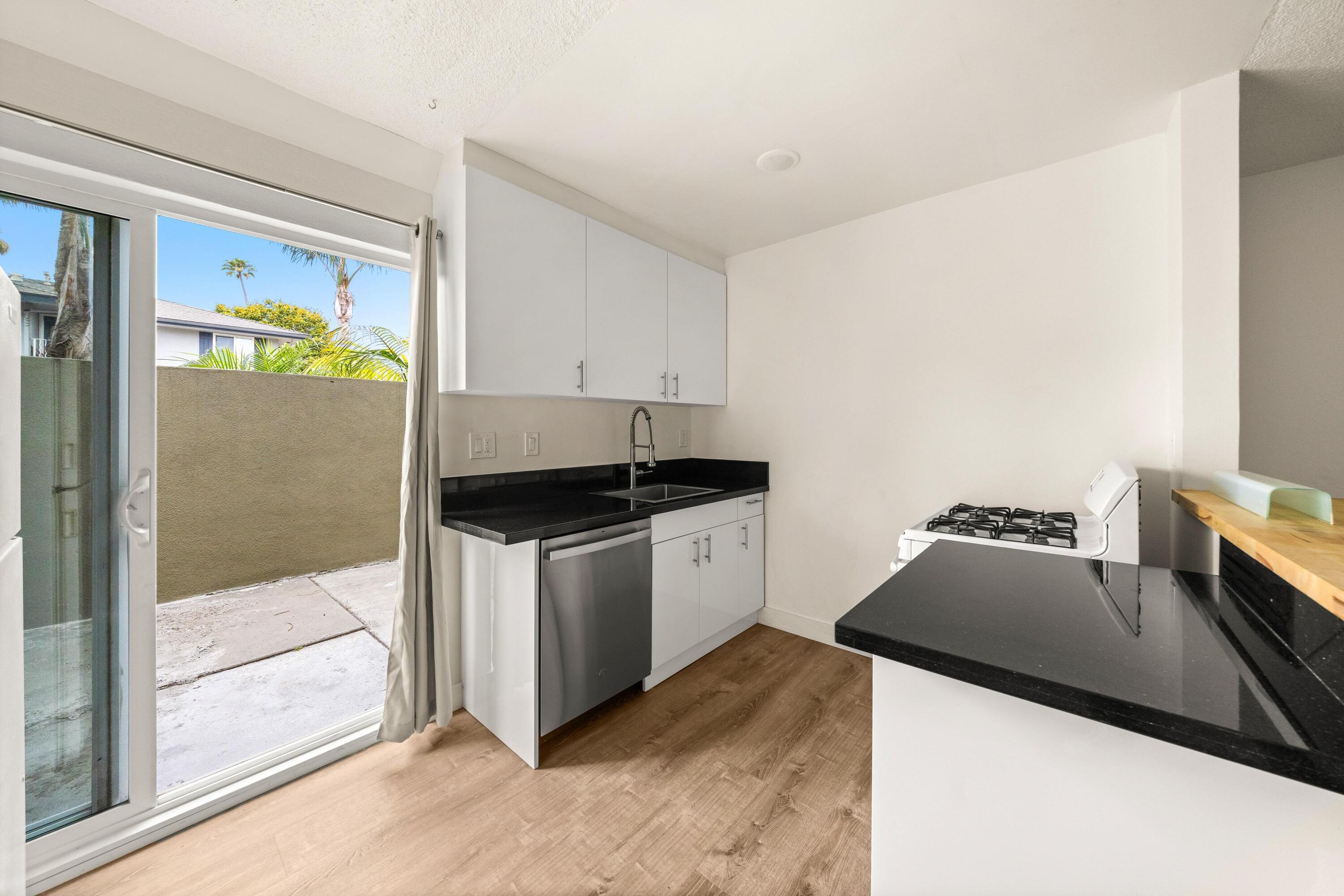 6597 Trigo Road Goleta, CA 93117 - Photo 7 of 20 a kitchen with a sink and a refrigerator