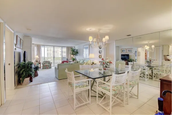 a view of a dining room with furniture and a kitchen