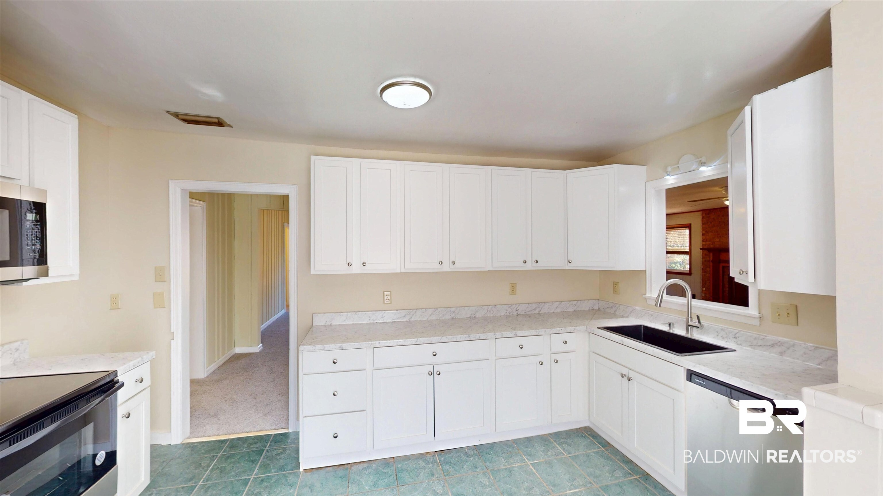 1471 Cedar Crescent Drive Mobile, AL 36605 - Photo 9 of 28 Kitchen with light countertops, stainless steel appliances, and white cabinets