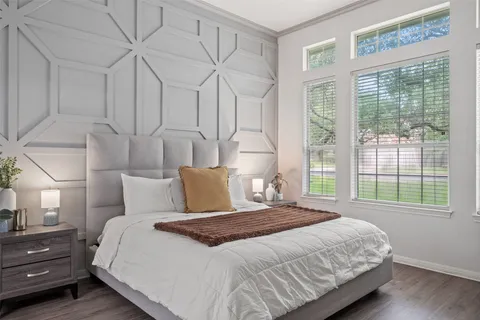 a large bed sitting in a bedroom next to a window