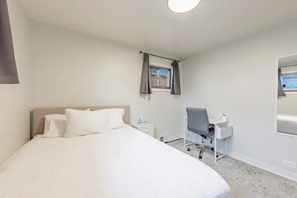 a bedroom with a bed and a desk