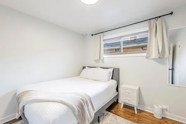 a bedroom with a bed and a chair
