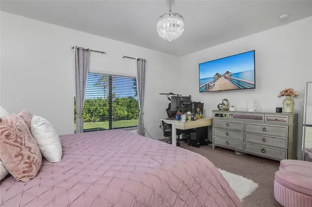 a bedroom with a large bed and a window