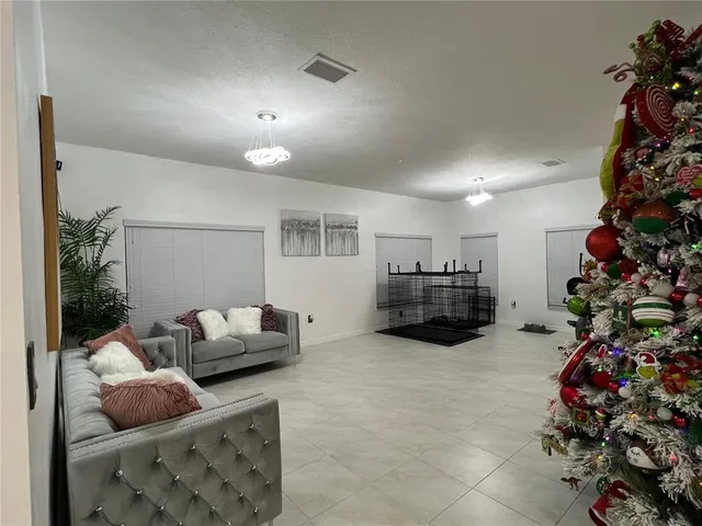 a living room with furniture and flowers