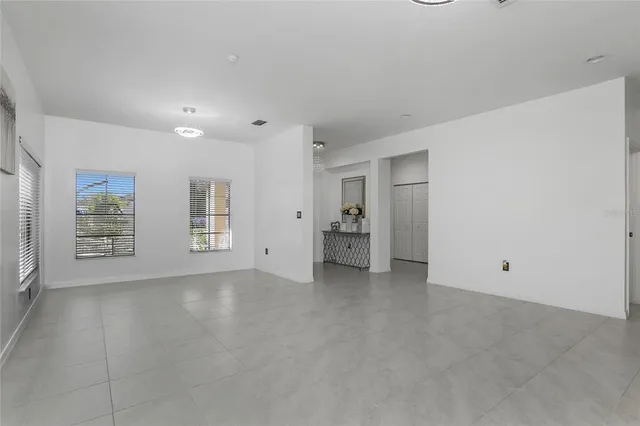 an empty room with windows and closet