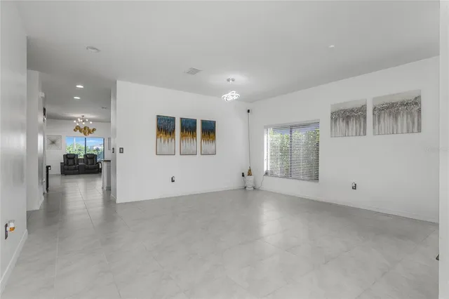 an empty room with windows and tables