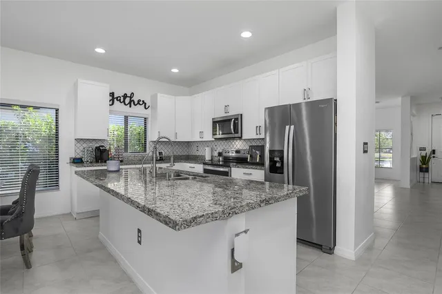 a kitchen with a sink stove and refrigerator