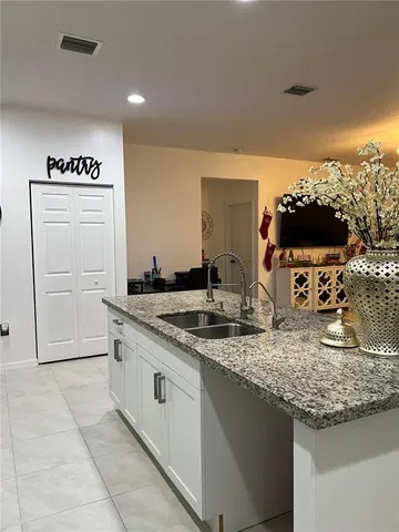 a kitchen with sink cabinets and microwave