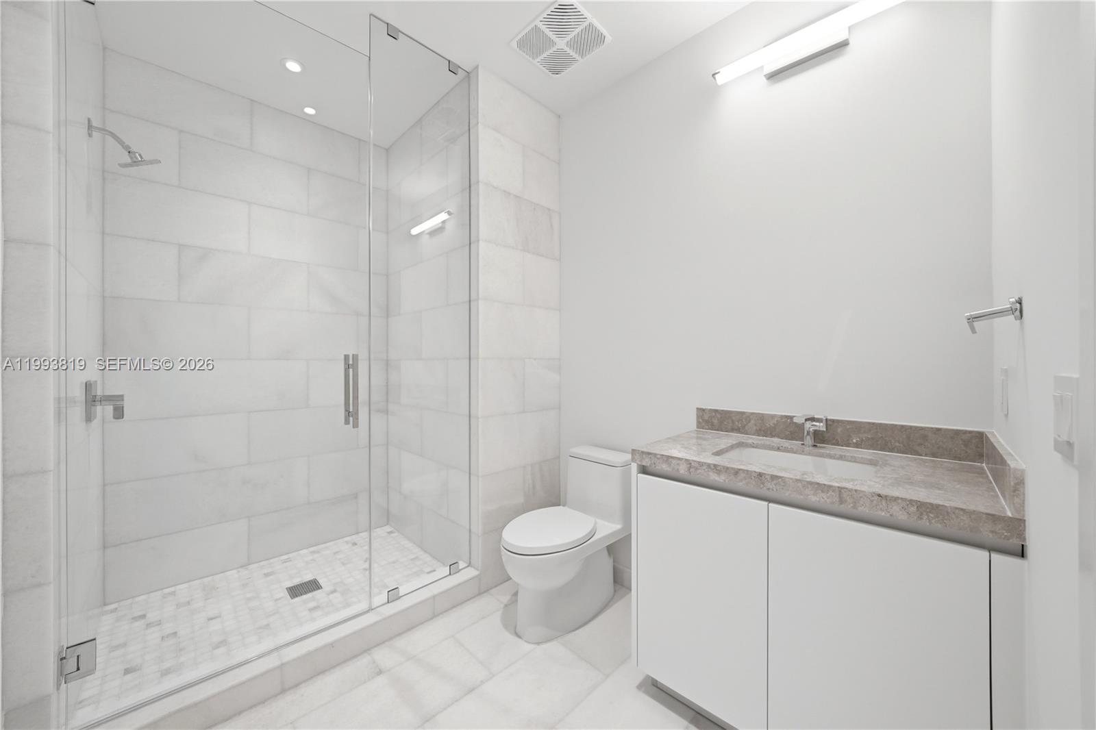 175 Southeast 25th Road, Unit 3102 Miami, FL 33129 - Photo 28 of 65 a bathroom with a granite countertop sink a toilet and shower