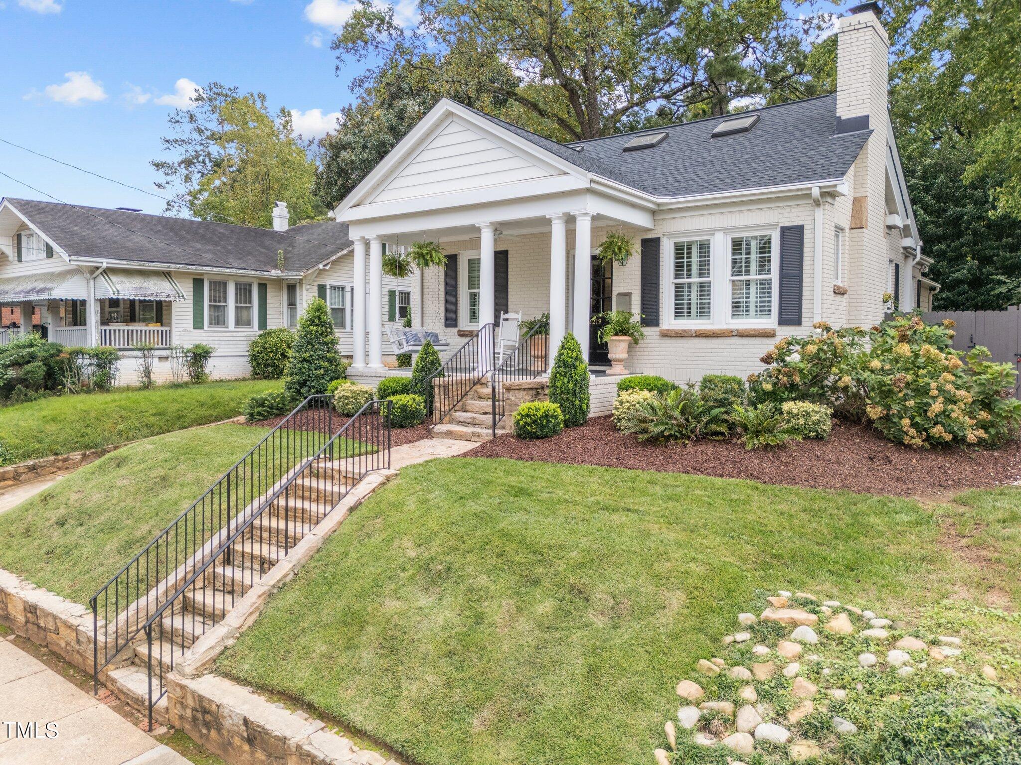 2219 Creston Road Raleigh, NC 27608 - Photo 2 of 45 a front view of a house with garden