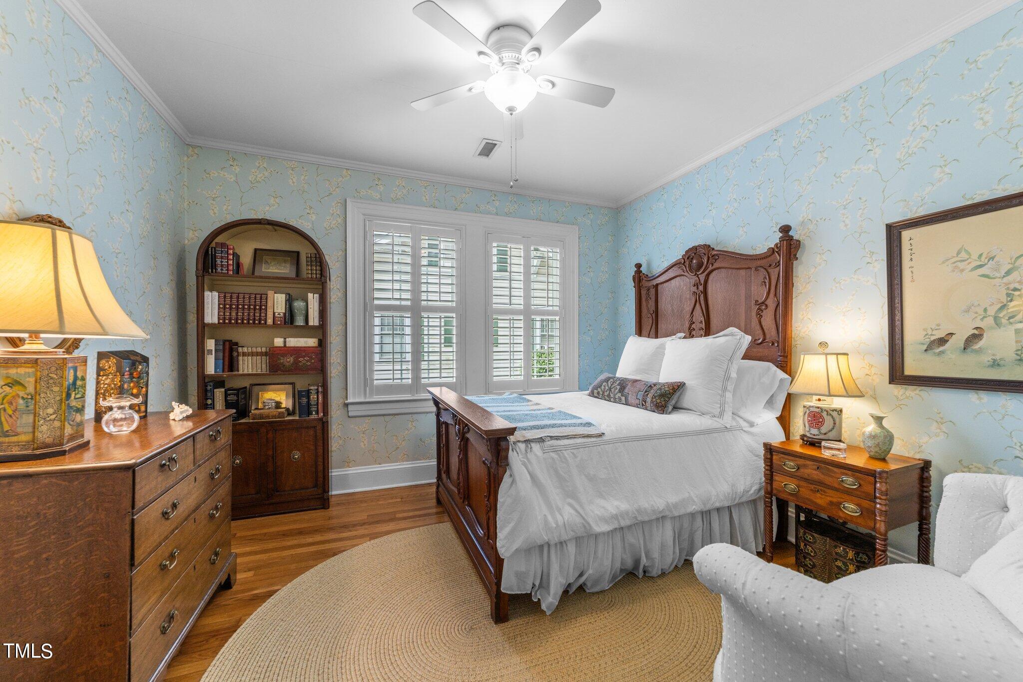 2219 Creston Road Raleigh, NC 27608 - Photo 23 of 45 a bed room with furniture and a chandelier