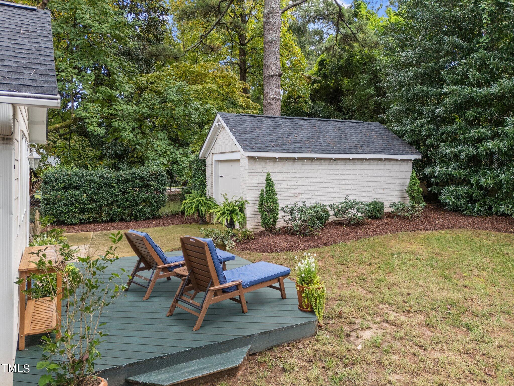 2219 Creston Road Raleigh, NC 27608 - Photo 33 of 45 a view of a house with backyard sitting area and garden