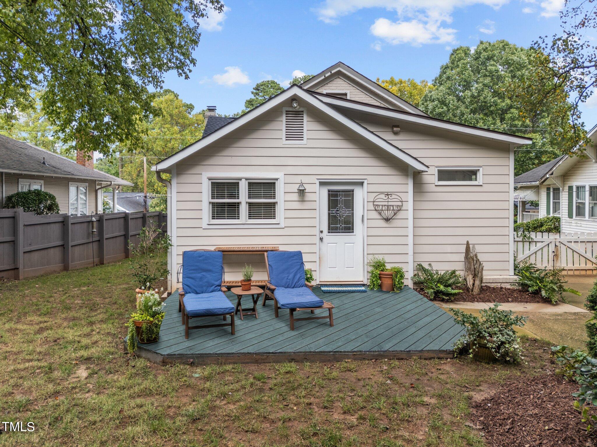 2219 Creston Road Raleigh, NC 27608 - Photo 36 of 45 a view of a house with a yard chairs and floor to ceiling window