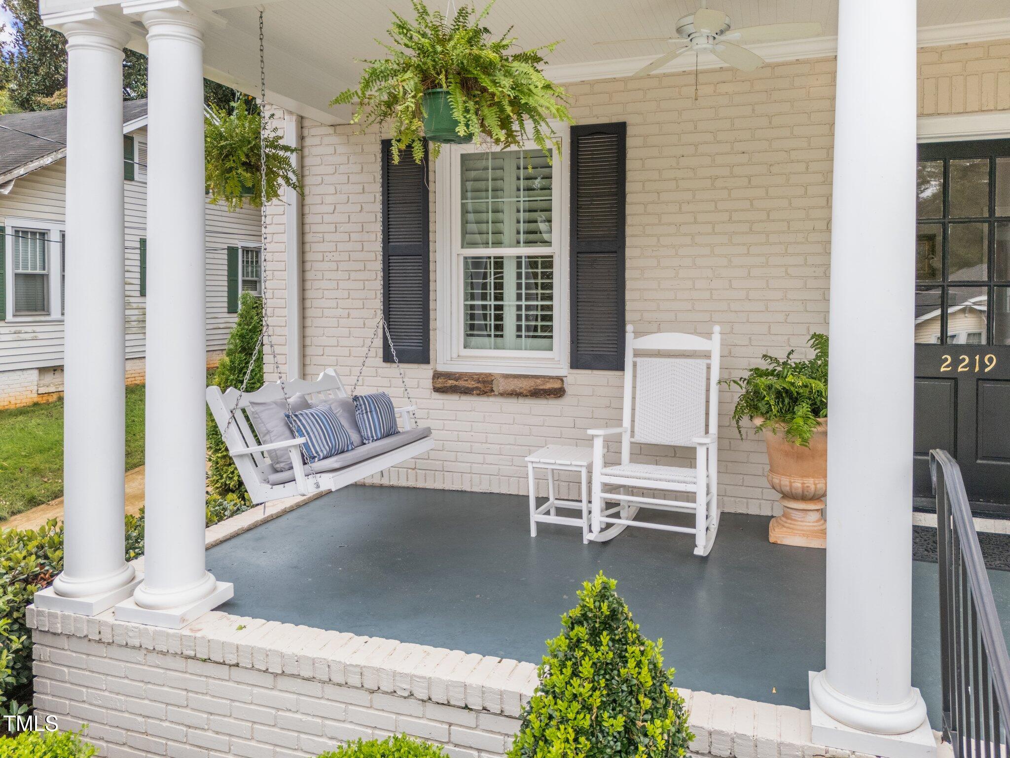 2219 Creston Road Raleigh, NC 27608 - Photo 40 of 45 a view of a patio with table and chairs and potted plants