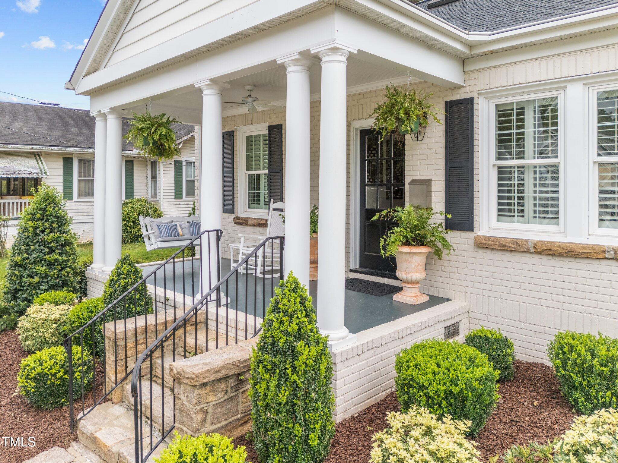 2219 Creston Road Raleigh, NC 27608 - Photo 4 of 45 a front view of a house with outdoor seating