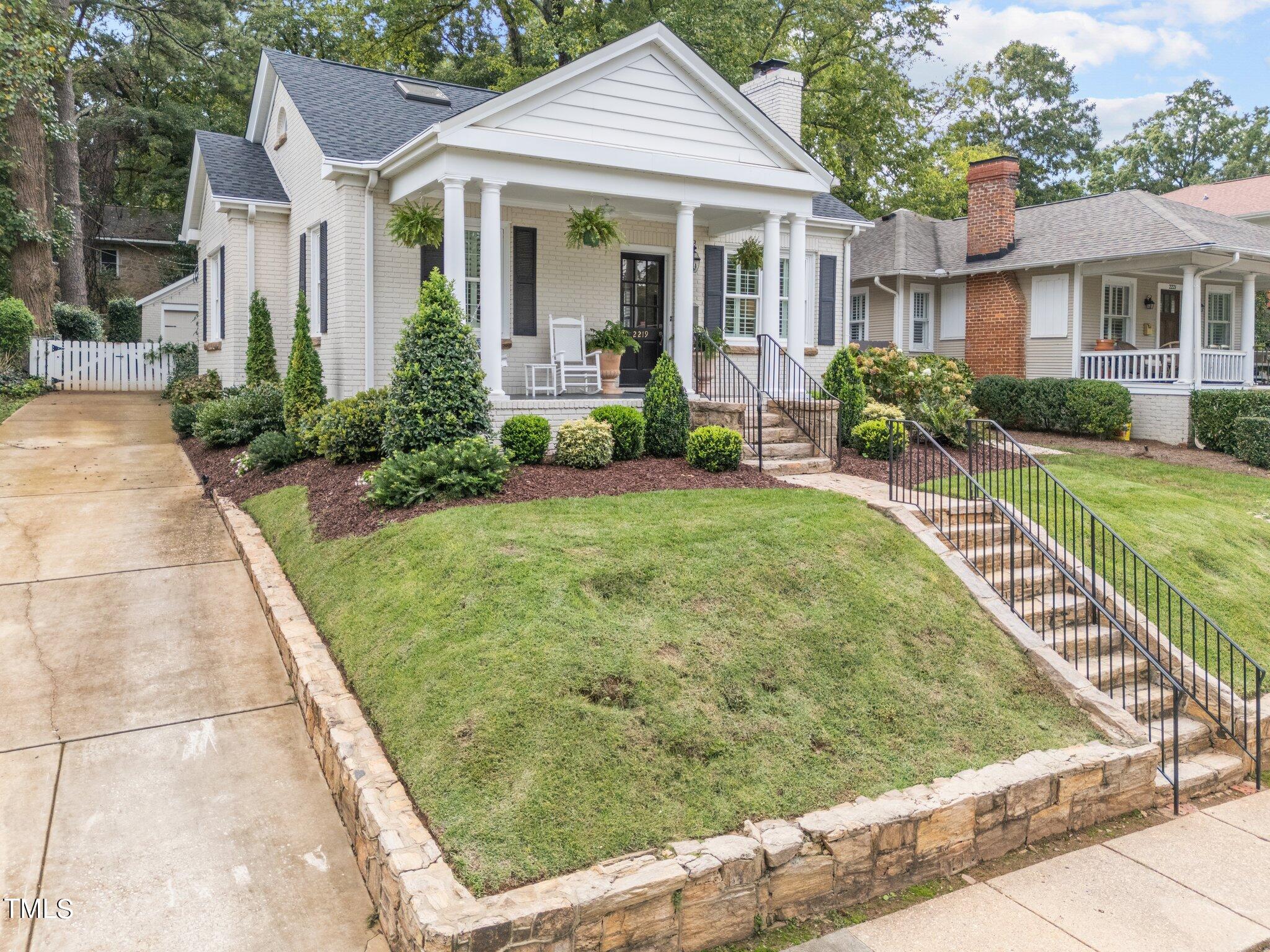 2219 Creston Road Raleigh, NC 27608 - Photo 5 of 45 a front view of a house with garden