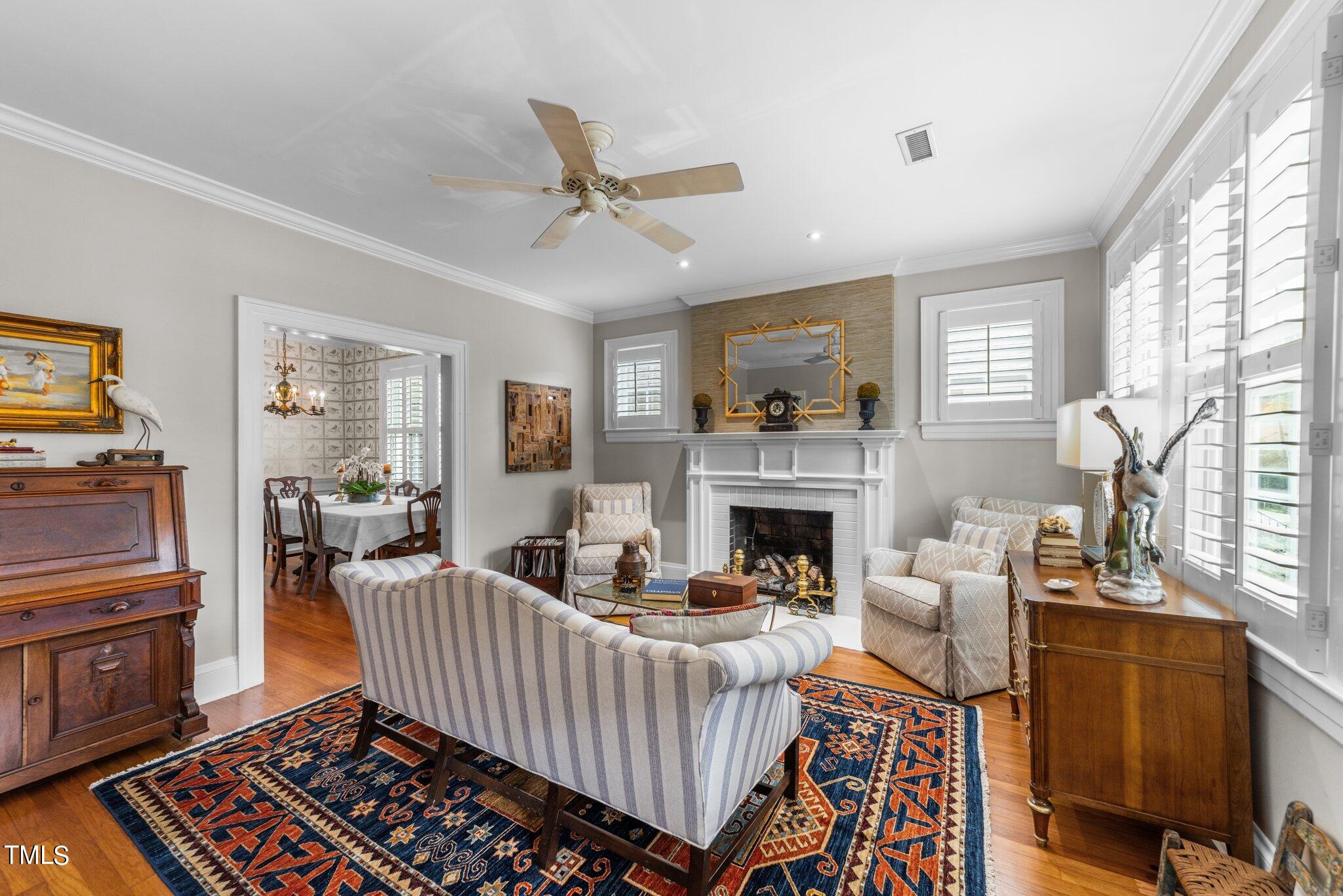 2219 Creston Road Raleigh, NC 27608 - Photo 9 of 45 a living room with furniture and a fireplace
