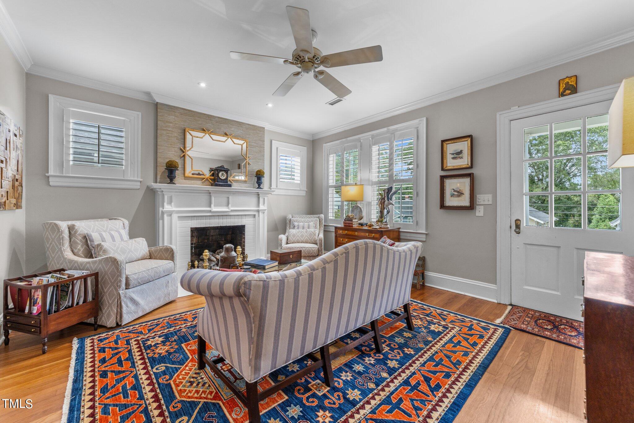 2219 Creston Road Raleigh, NC 27608 - Photo 10 of 45 a living room with furniture and a fireplace
