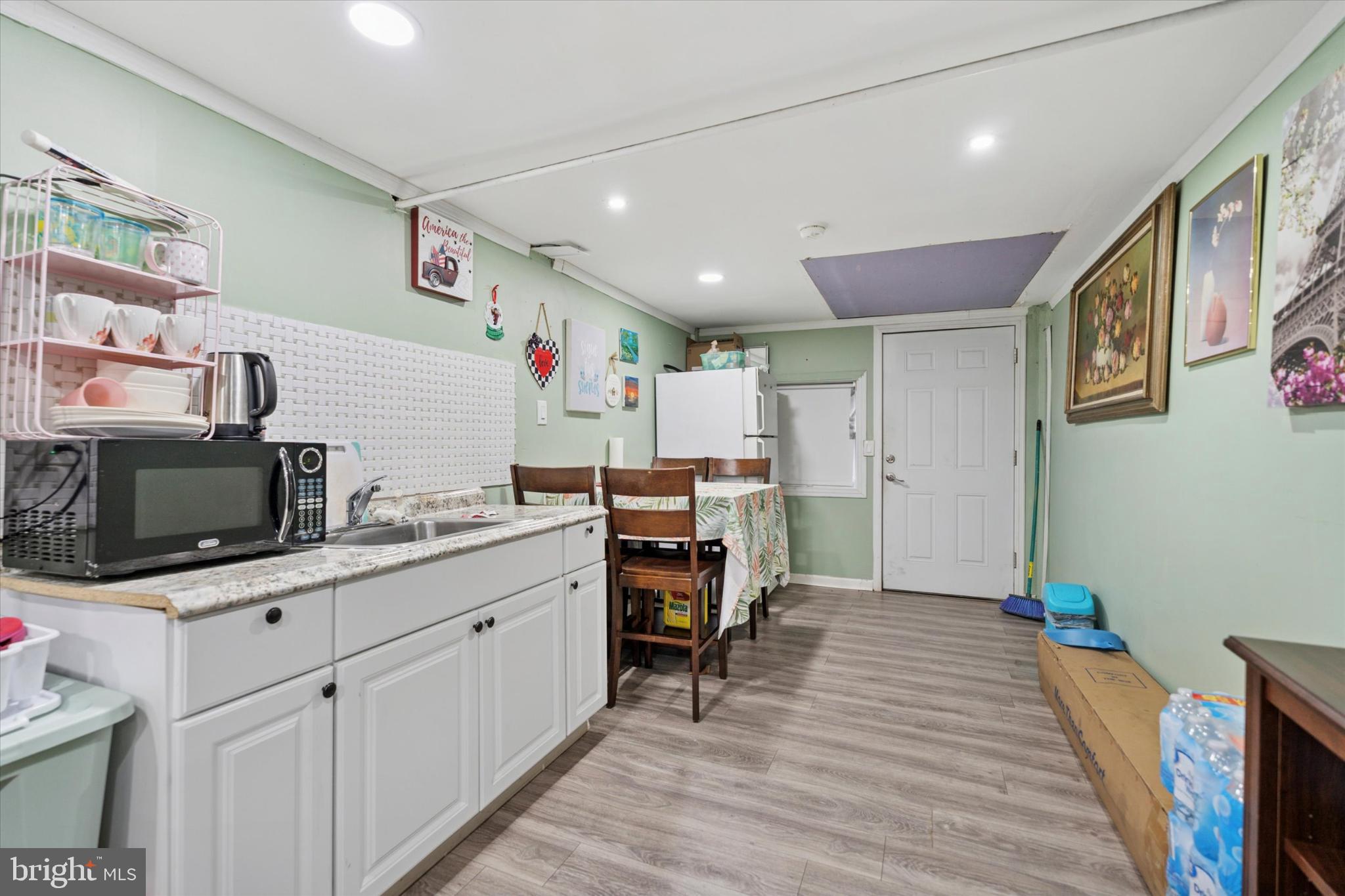 2548 Irvington Road Drexel Hill, PA 19026 - Photo 12 of 15 a room with furniture a flat screen tv and kitchen view