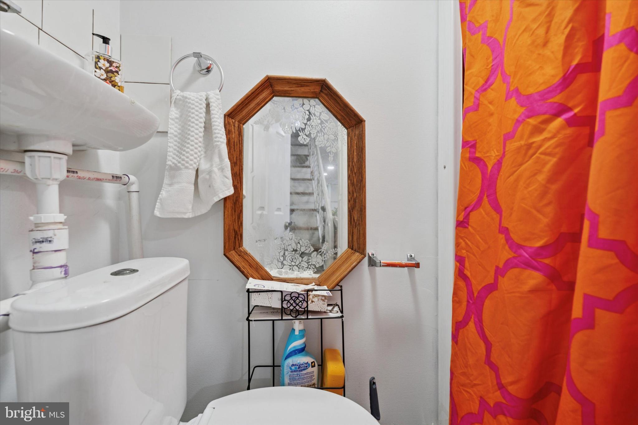 2548 Irvington Road Drexel Hill, PA 19026 - Photo 6 of 15 a bathroom with a toilet sink and mirror