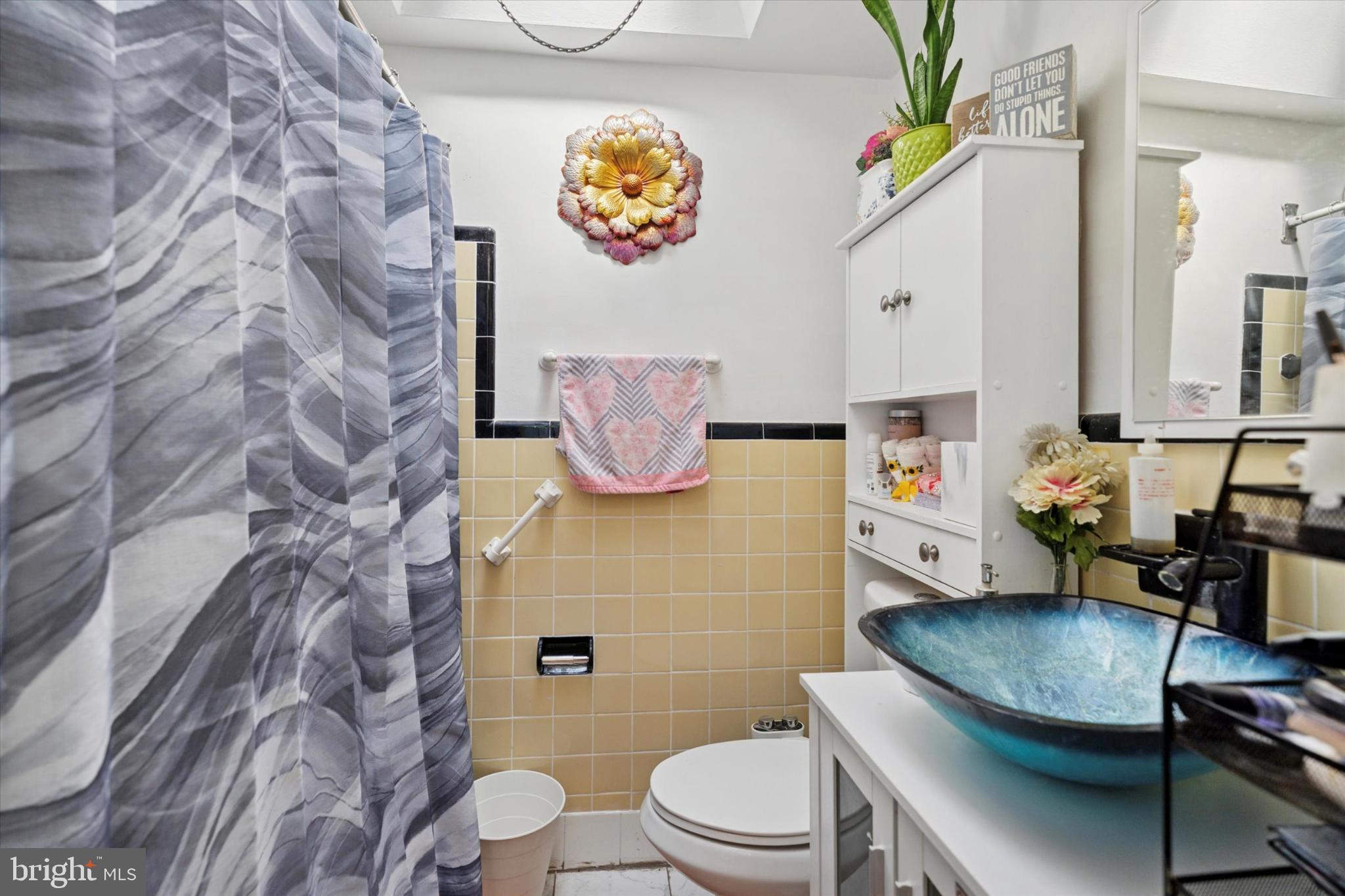 2548 Irvington Road Drexel Hill, PA 19026 - Photo 10 of 15 a bathroom with a toilet a sink and a shower curtain