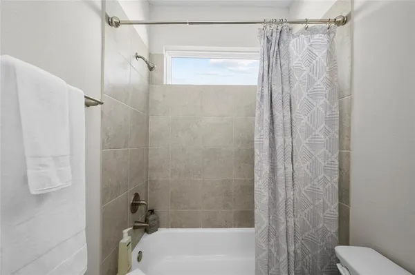 a bathroom with a shower and a toilet